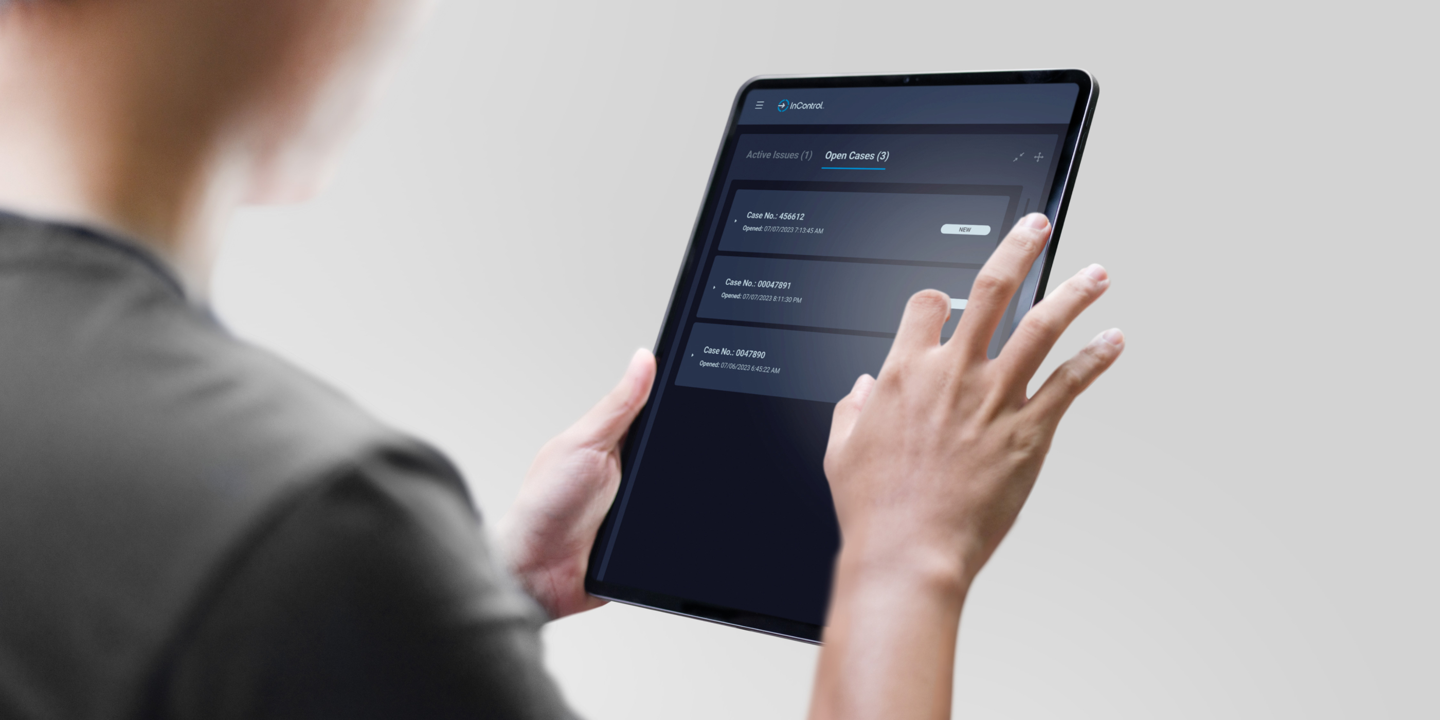 holding a tablet looking at InControl's cases list