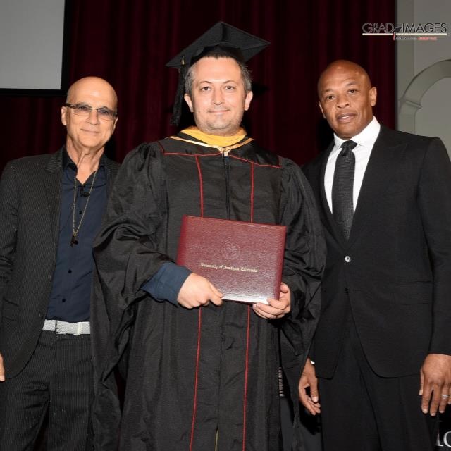 Russell Schmidt receiving his diploma from Dr. Dre and Jimmy Iovine at USC Iovine & Young Academy graduation